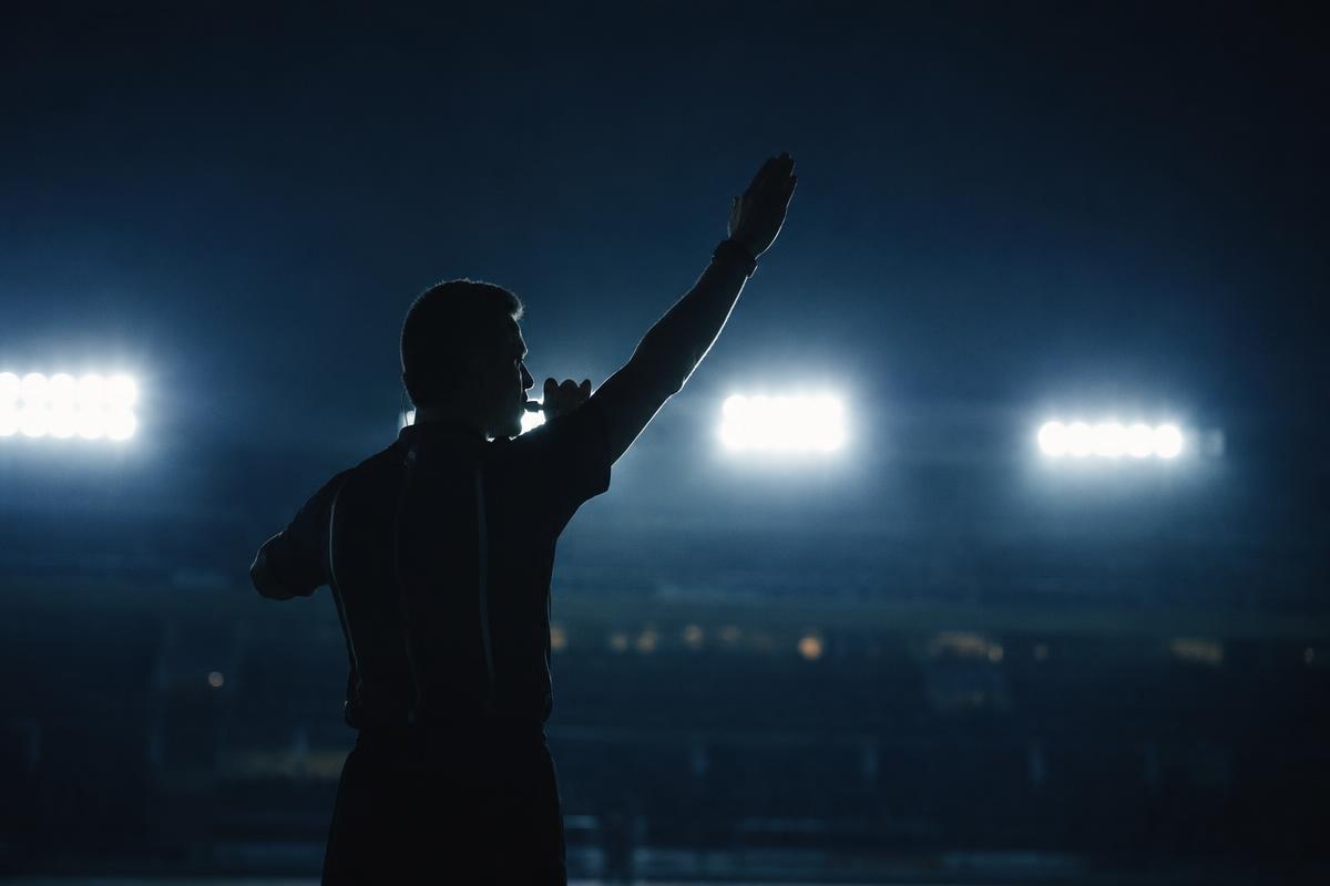 Silhouette of a referee on a lower league pitch